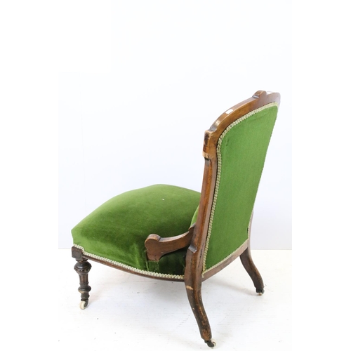 647 - Edwardian nursing chair, with carved back, upholstered in green with button back, on turned legs and... 