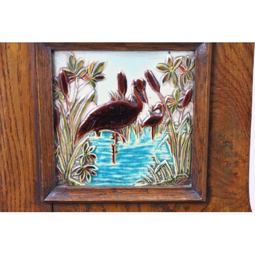 649 - Victorian oak hall chair with Majolica inset tile to back, 90cm high x 44cm wide x 36cm deep