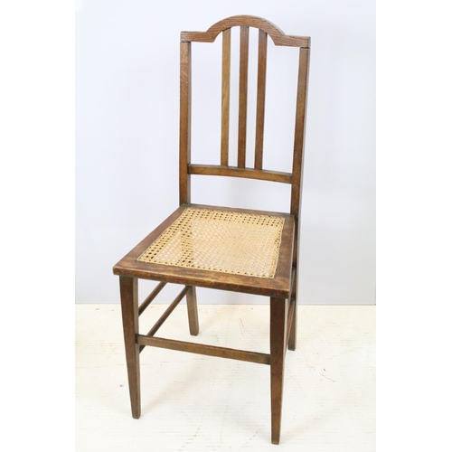 652 - Edwardian low chair, the top rail carved with a flower and foliage, above spindles, the back and sea... 