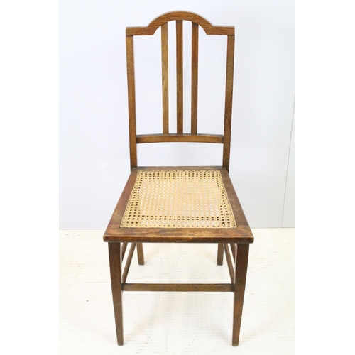 652 - Edwardian low chair, the top rail carved with a flower and foliage, above spindles, the back and sea... 