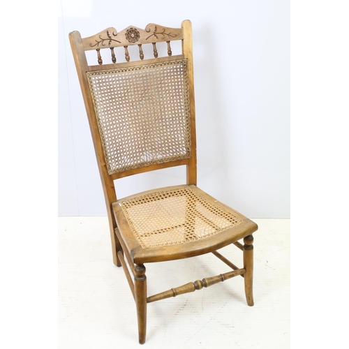 652 - Edwardian low chair, the top rail carved with a flower and foliage, above spindles, the back and sea... 