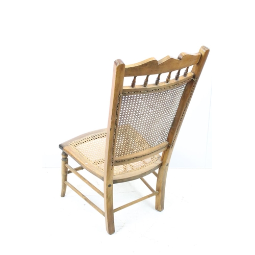 652 - Edwardian low chair, the top rail carved with a flower and foliage, above spindles, the back and sea... 