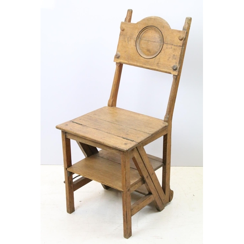 653 - Arts and Crafts metamorphic library chair, the arched backrest with a central circular panel, on cha... 
