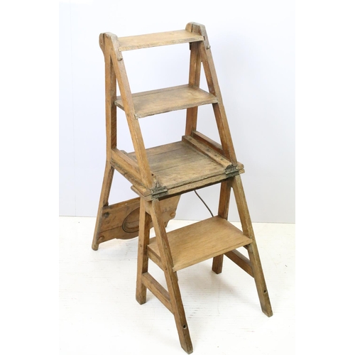 653 - Arts and Crafts metamorphic library chair, the arched backrest with a central circular panel, on cha... 