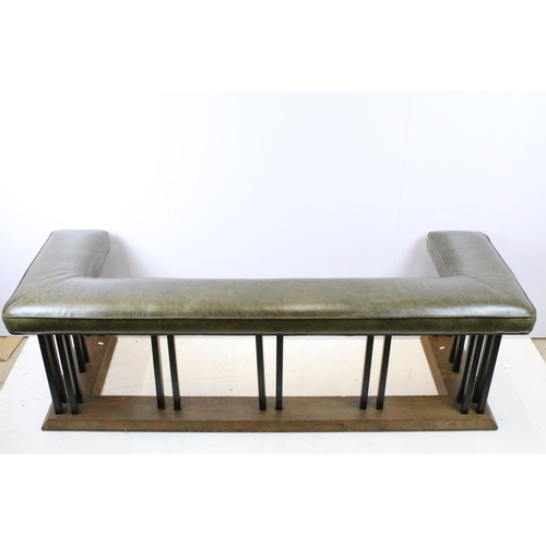 657 - Green leather club fender, the cushioned green leather top above black metal supports and oak base, ... 