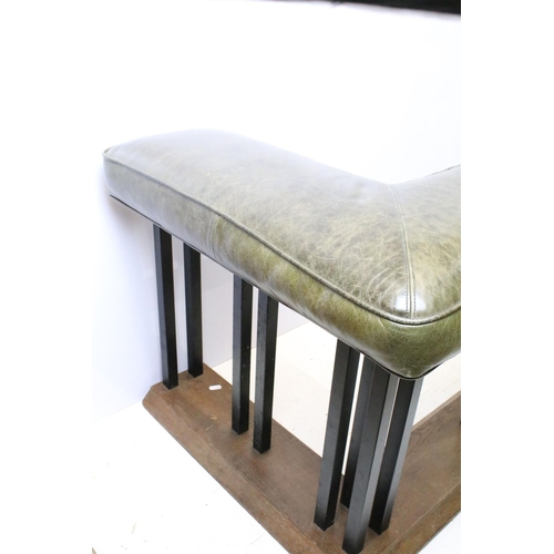 657 - Green leather club fender, the cushioned green leather top above black metal supports and oak base, ... 