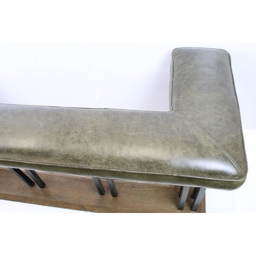 657 - Green leather club fender, the cushioned green leather top above black metal supports and oak base, ... 