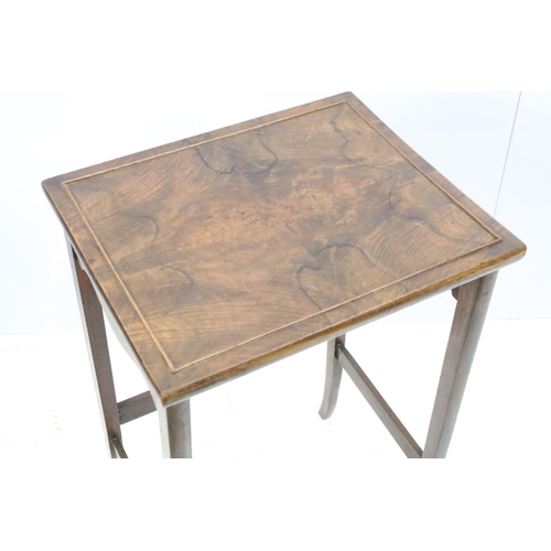 657A - Nest of three walnut coffee tables, the largest, 61cm high x 44cm wide x 33cm deep