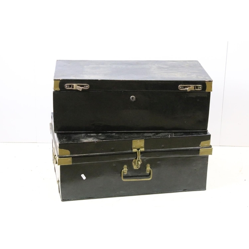 663 - Two large black painted storage trunks with brass fittings