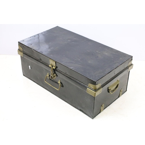 663 - Two large black painted storage trunks with brass fittings
