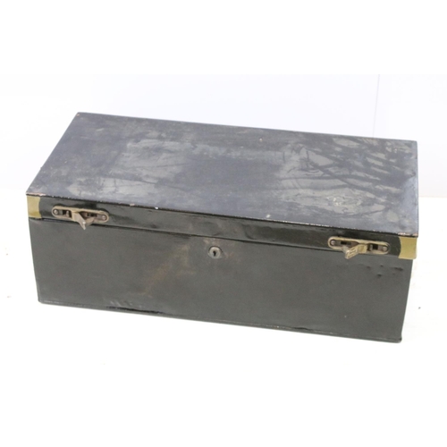 663 - Two large black painted storage trunks with brass fittings