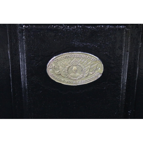 663 - Two large black painted storage trunks with brass fittings