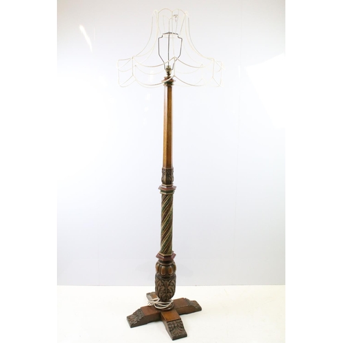669A - 20th century substantial carved oak standard lamp, the four feet carved with flowers and leaves, the... 