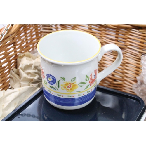 672 - Wicker picnic hamper containing a four piece place setting