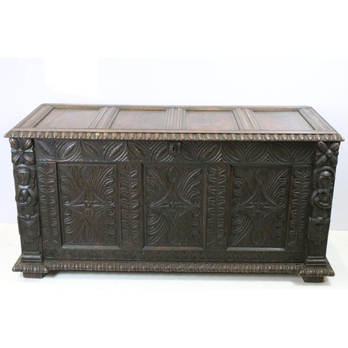 676 - 19th century carved oak chest of substantial proportions, the four panelled lid above carved front, ... 