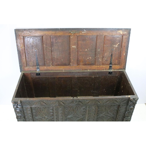 676 - 19th century carved oak chest of substantial proportions, the four panelled lid above carved front, ... 