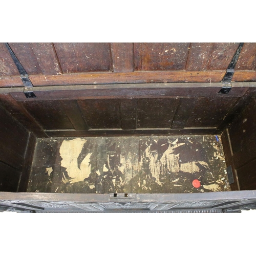 676 - 19th century carved oak chest of substantial proportions, the four panelled lid above carved front, ... 