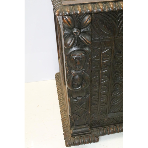 676 - 19th century carved oak chest of substantial proportions, the four panelled lid above carved front, ... 