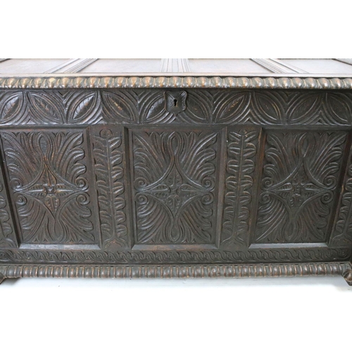 676 - 19th century carved oak chest of substantial proportions, the four panelled lid above carved front, ... 