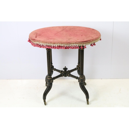 688 - Ebonized occasional table, of x-stretcher form, with fringed velvet covered oval top, on turned curv... 