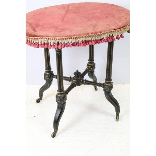 688 - Ebonized occasional table, of x-stretcher form, with fringed velvet covered oval top, on turned curv... 
