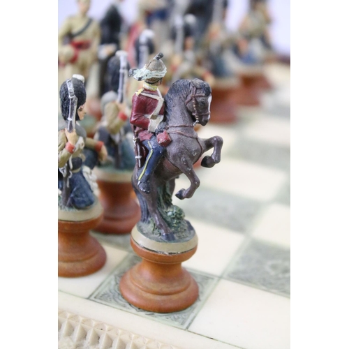 695 - Franklin Mint The Raj Chess Set with marble effect chess board within a mahogany frame raised on a b... 