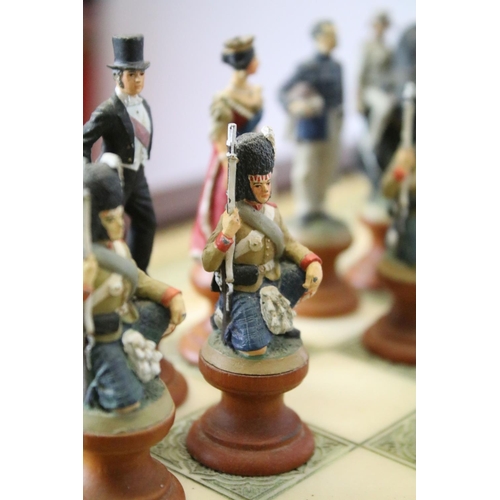 695 - Franklin Mint The Raj Chess Set with marble effect chess board within a mahogany frame raised on a b... 