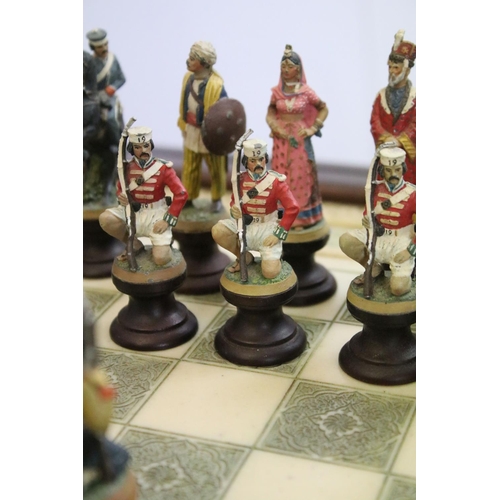 695 - Franklin Mint The Raj Chess Set with marble effect chess board within a mahogany frame raised on a b... 