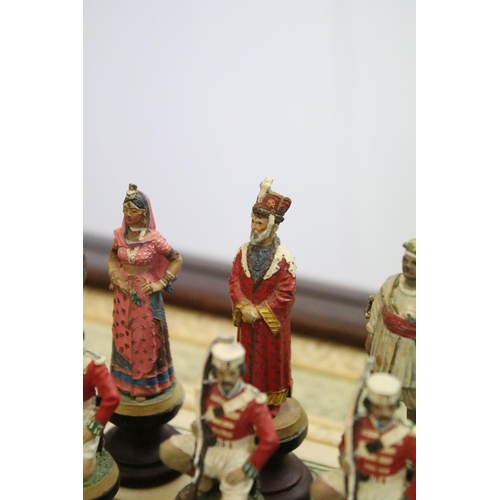 695 - Franklin Mint The Raj Chess Set with marble effect chess board within a mahogany frame raised on a b... 