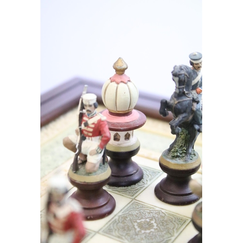 695 - Franklin Mint The Raj Chess Set with marble effect chess board within a mahogany frame raised on a b... 