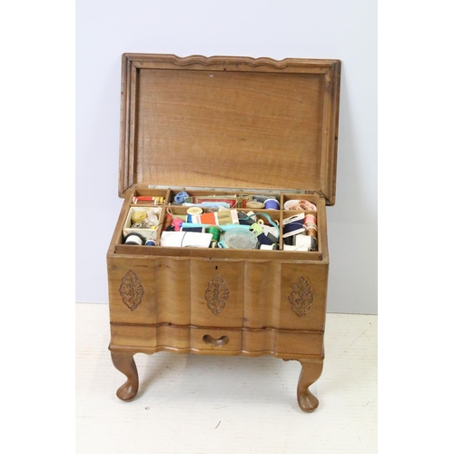 700 - 20th century carved sewing box, with drawer below on cabriole legs, with extensive contents includin... 