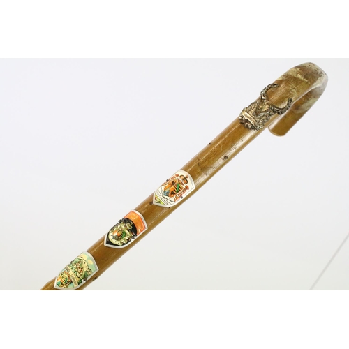 129 - Hand carved African walking stick with lion masks, together with a vintage Bavarian walking stick wi... 