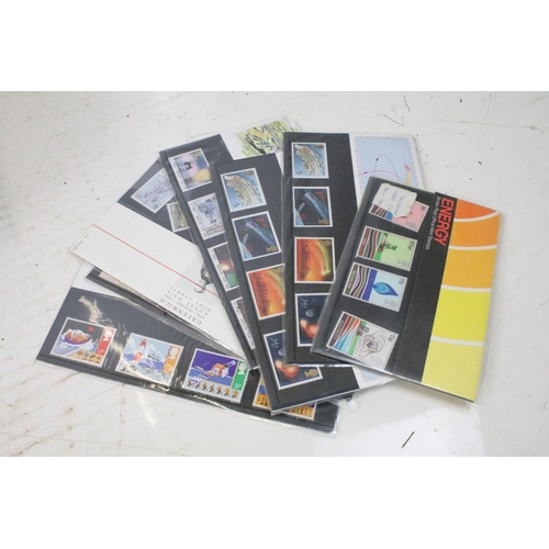 458 - Approximately 100 loose late 20th Century presentation pack stamps, together with an album of Guerns... 