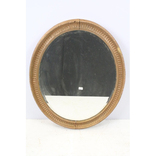 640 - Bevelled glass mirror of oval form with oval painted plaster frame