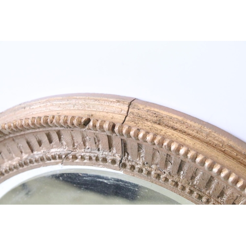 640 - Bevelled glass mirror of oval form with oval painted plaster frame