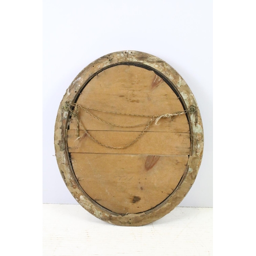 640 - Bevelled glass mirror of oval form with oval painted plaster frame