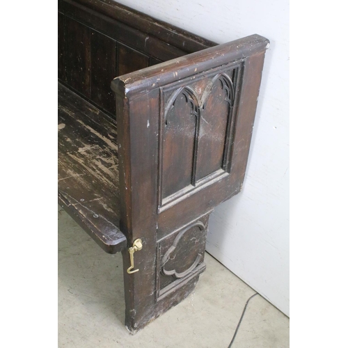 668 - Stained panelled pew, the end carved with arches and quatrefoil design, 81cm high x 207cm wide x 48c... 