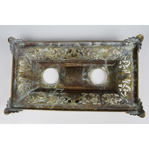 106 - Cast brass inkstand with ornate scrolling and lion mask detail, with hinged cover, approx 35cm wide