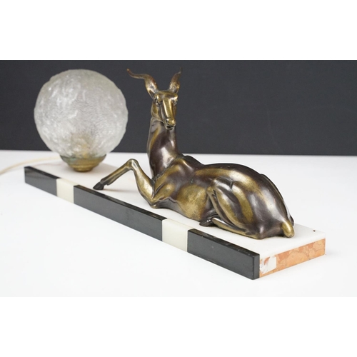 117 - Art Deco Table Lamp mounted with an Antelope and globular glass shade on a marble plinth base, appro... 