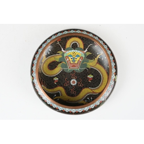 124 - Chinese cloisonne enamel circular dish decorated with dragons on a black ground, character marks to ... 