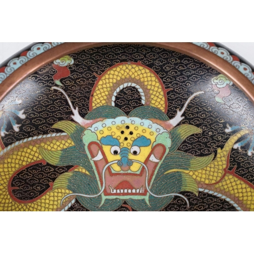 124 - Chinese cloisonne enamel circular dish decorated with dragons on a black ground, character marks to ... 