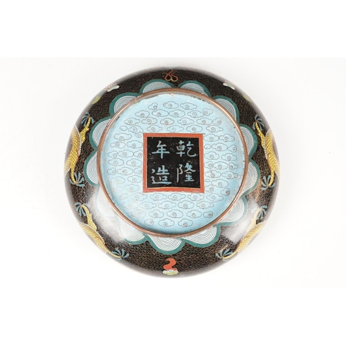 124 - Chinese cloisonne enamel circular dish decorated with dragons on a black ground, character marks to ... 