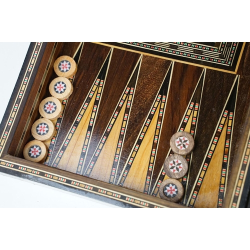 134 - Parquetry inlaid wooden games box, with internal backgammon board and external chess / draughts boar... 