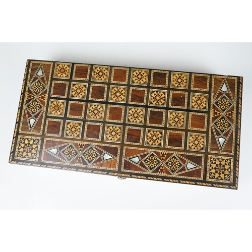 134 - Parquetry inlaid wooden games box, with internal backgammon board and external chess / draughts boar... 