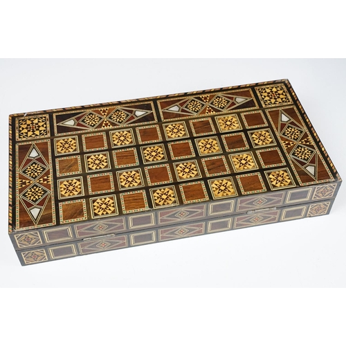 134 - Parquetry inlaid wooden games box, with internal backgammon board and external chess / draughts boar... 