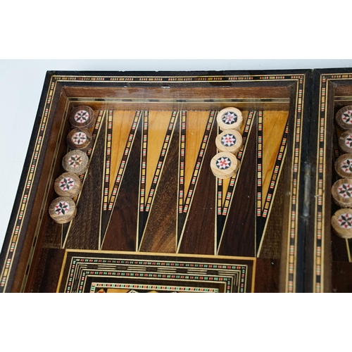 134 - Parquetry inlaid wooden games box, with internal backgammon board and external chess / draughts boar... 