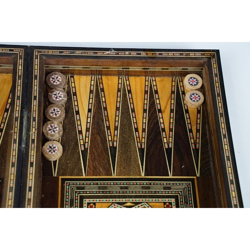 134 - Parquetry inlaid wooden games box, with internal backgammon board and external chess / draughts boar... 