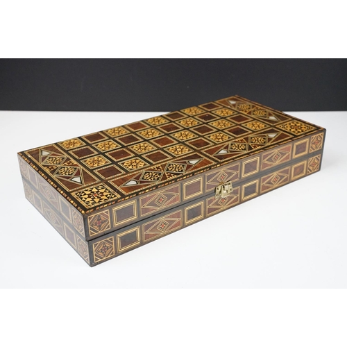 134 - Parquetry inlaid wooden games box, with internal backgammon board and external chess / draughts boar... 