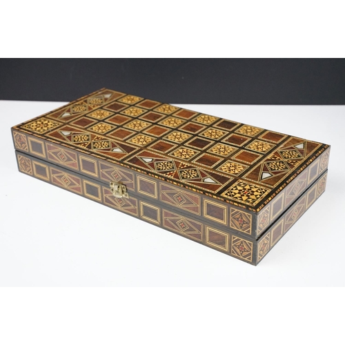 134 - Parquetry inlaid wooden games box, with internal backgammon board and external chess / draughts boar... 