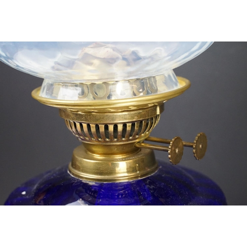 135 - Early-to-mid 20th C oil lamp with opalescent flared glass shade, chimney, cobalt blue glass font and... 